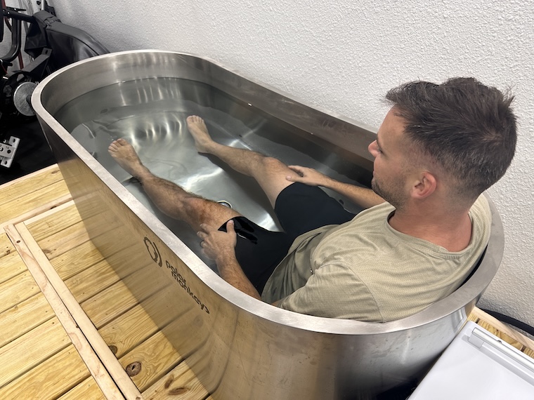 a person sitting in a cold plunge tub