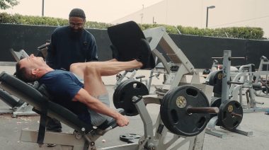 Charles Glass trains a client on the leg press machine.