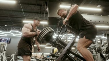 Martin Fitzwater provides encouragement to Chris Bumstead during a set of a rowing exercise.