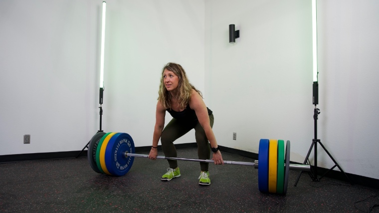 Our tester getting ready to lift a Major Fitness Barbell Advanced with all four plates on