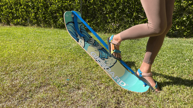 A woman tips the GiBoard balance board, while still maintaining balance.