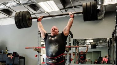 Mitchell Hooper performs an overhead press.