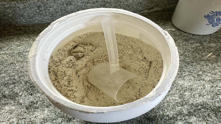 An open container of Nutricost Whey Protein Isolate