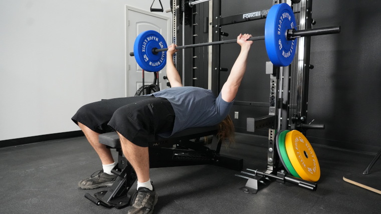 Our tester benchpressing the Rogue 2.0 Barbell