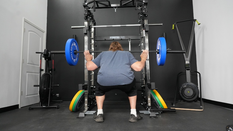 Our tester does squats with the Rogue 2.0 Barbell