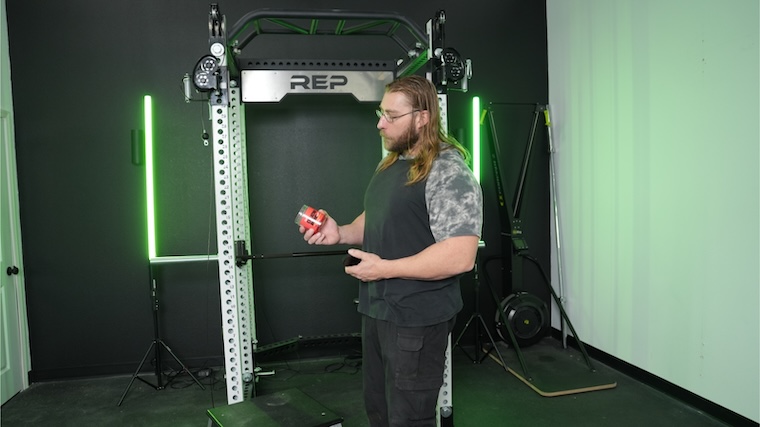 Our tester holding a tub of Swoly Creatine Gummies