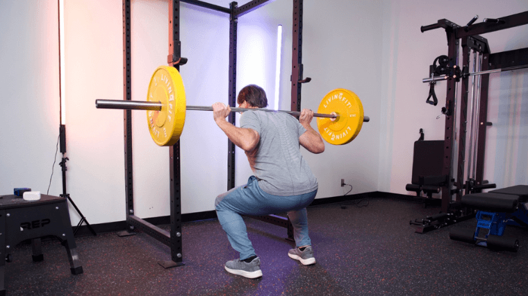 Our tester performing a back squat while working out with the Titan T3 Power Rack