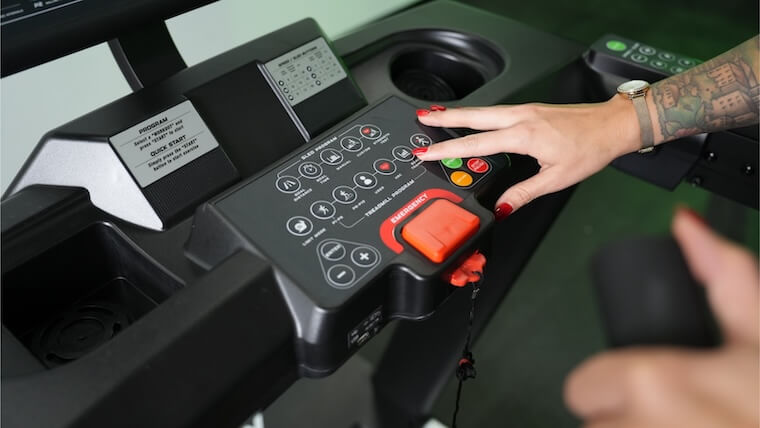 Our tester adjusting the controls on the Xebex ST-6000 Treadmill.