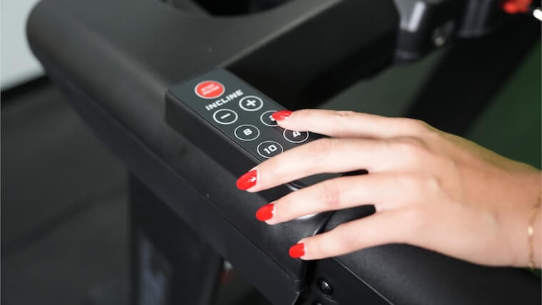 Our tester adjusting the incline on the Xebex ST-6000 Treadmill.