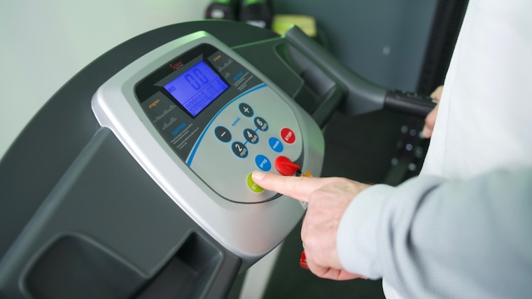 Our tester adjusting the console of the Sunny Health & Fitness SF-T7603 Treadmill.