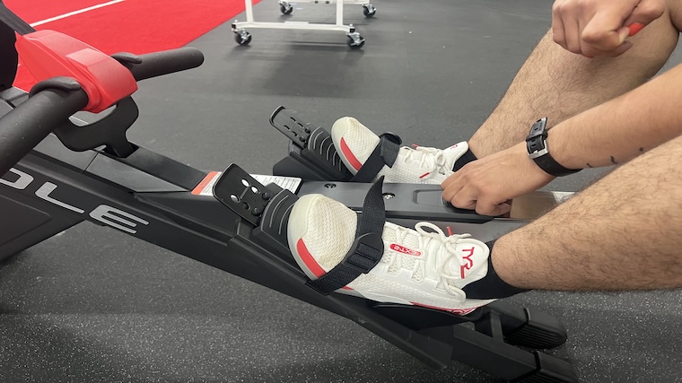 Our tester adjusting the footstraps on the Sole SR550 rowing machine