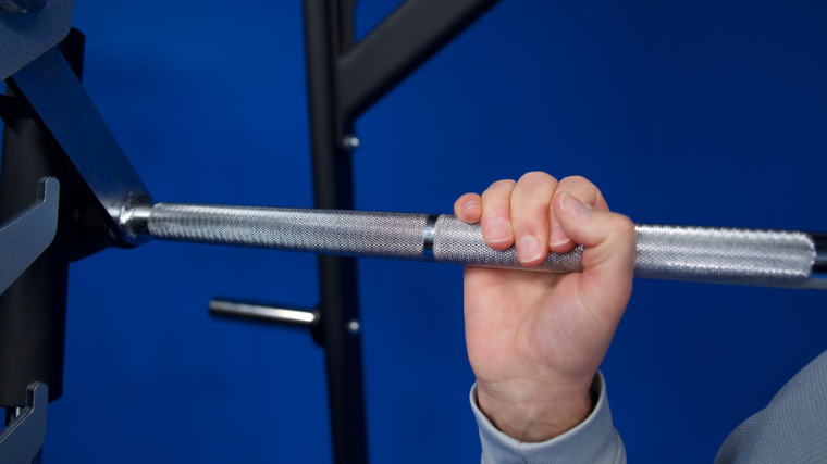 Our tester grasping the barbell knurling featured on the Titan Fitness Smith Machine