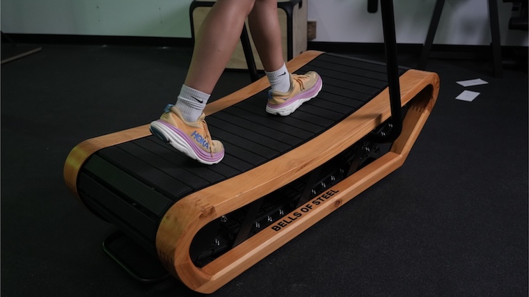 Our tester walking on the Bells of Steel Wooden Residential Treadmill