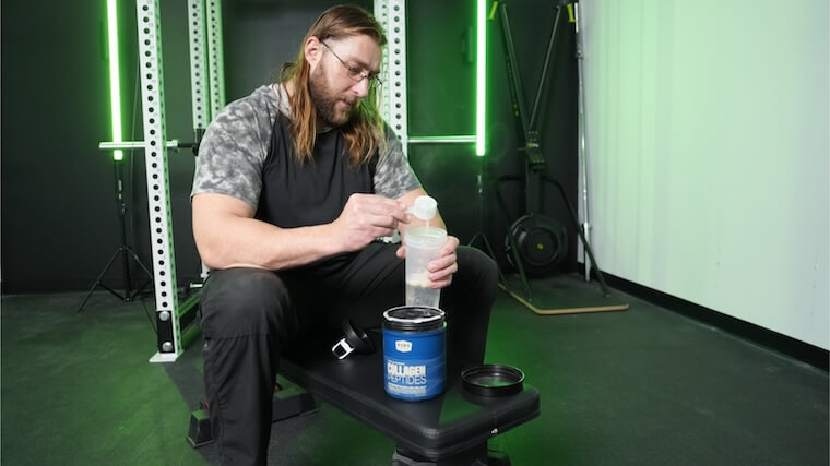 Our tester pouring a scoop of BUBS Naturals Collagen into their shaker bottle