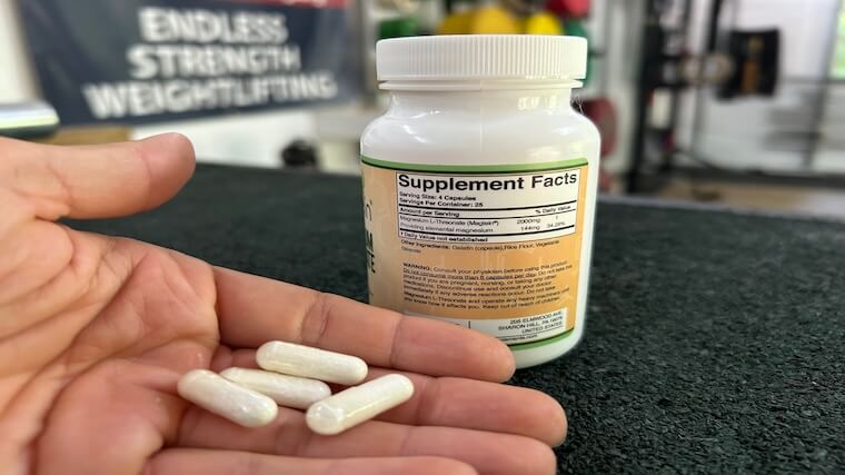 Our tester holding a handful of Double Wood Magnesium capsules