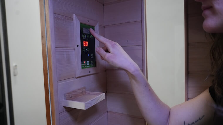 Our tester adjusting the settings for the Dynamic Andora 2-Person Infrared Sauna