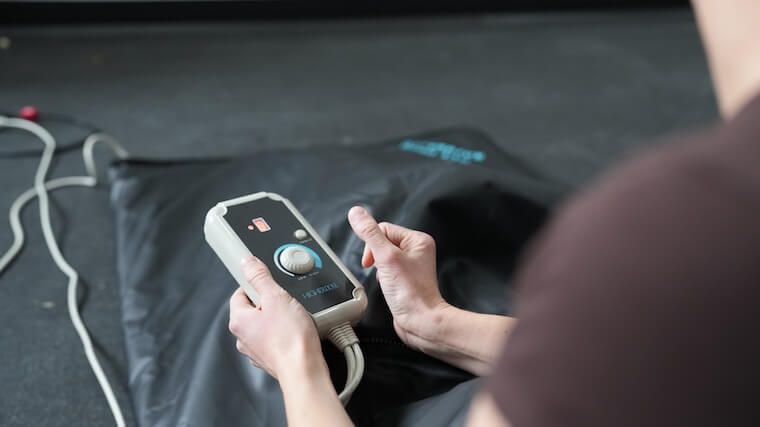 Our tester adjusting the controls of the HigherDOSE Infrared Sauna Blanket