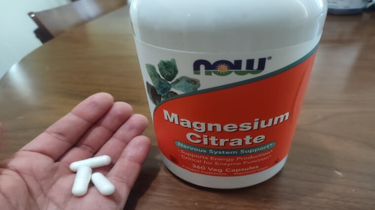 Our tester holding a handful of NOW Foods Magnesium Citrate capsules