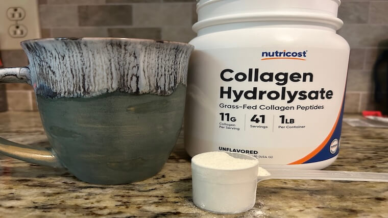 A single scoop of Nutricost Collagen next to a cup of coffee