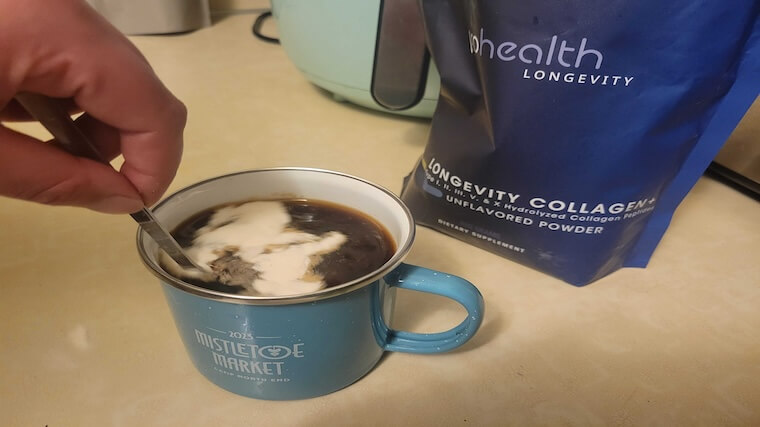 Our tester stirring a serving of Pro Health Longevity Collagen into their morning coffee