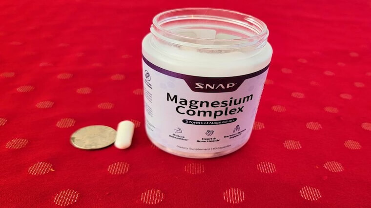 Snap Supplements Magnesium Complex capsule in comparison to a quarter