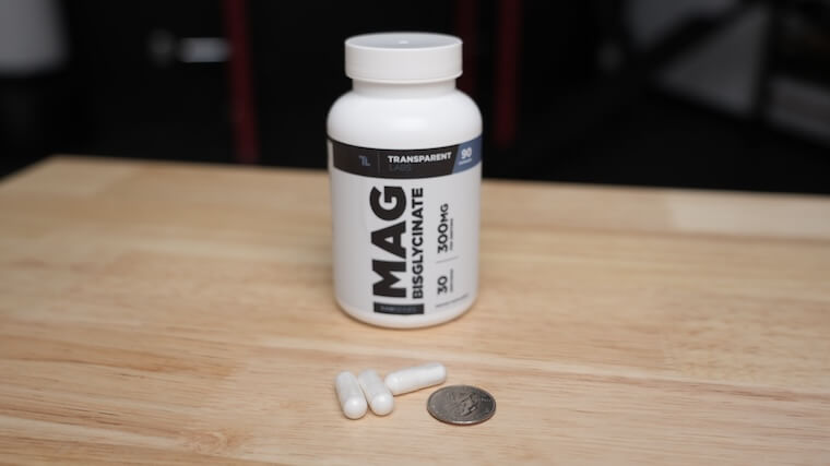 Transparent Labs Mag Bisglycinate capsules in comparison to a quarter