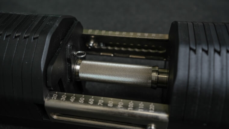 The knurled handle and adjustment settings of the REP Fitness REP x Pepin Adjustable Dumbbell