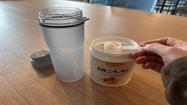 Our tester grabbing a scoop of Snap Supplements BCAAs