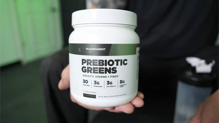 Our tester holding a tub of Transparent Labs Prebiotic Greens