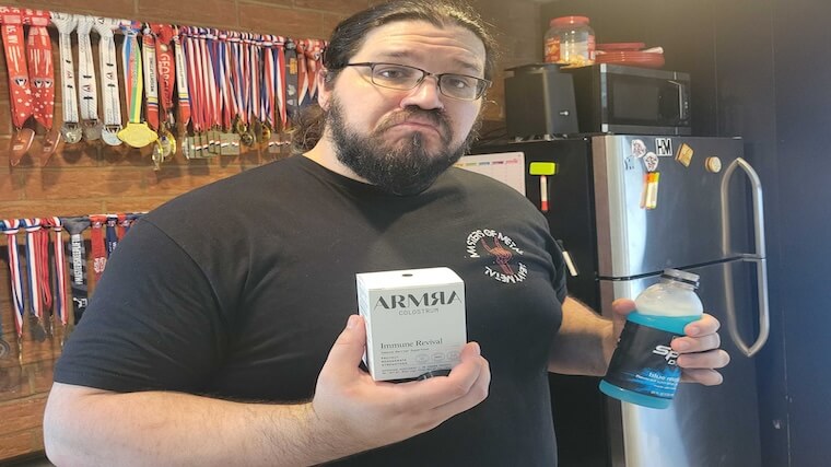 Our tester holding a box of ARMRA Colostrum travel packs
