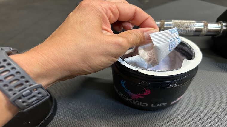 Our tester opening a container of Bucked Up Pre-Workout