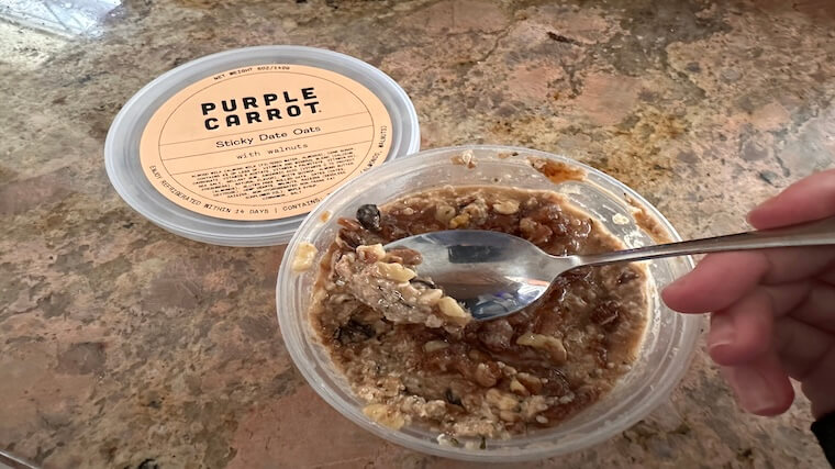 Our tester enjoying a serving of Sticky Date Oats from Purple Carrot