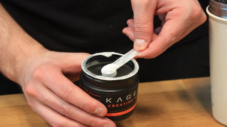 Our tester grabbing a scoop of Kaged Creatine HCl