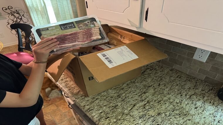 Our tester showing off their promotion-related ButcherBox item — free bacon for life