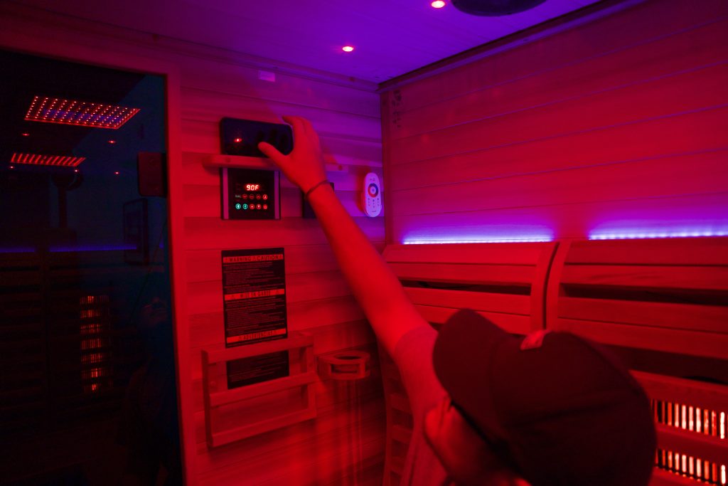 Tester using control panel in Sun Home Luminar 5-Person Sauna