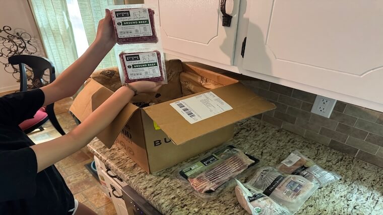 Our tester unboxing their recent ButcherBox delivery