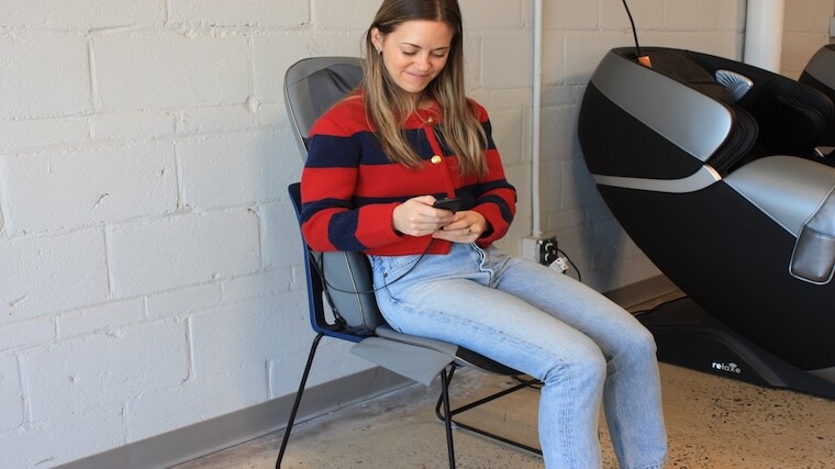 Our tester making some adjustments during their massage session with the Homedics Shiatsu Elite II massage chair