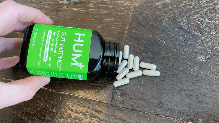 Our tester pouring out some HUM Nutrition Gut Instinct capsules