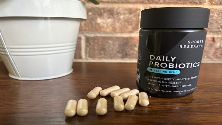 Sports Research Probiotic capsules on a wooden table