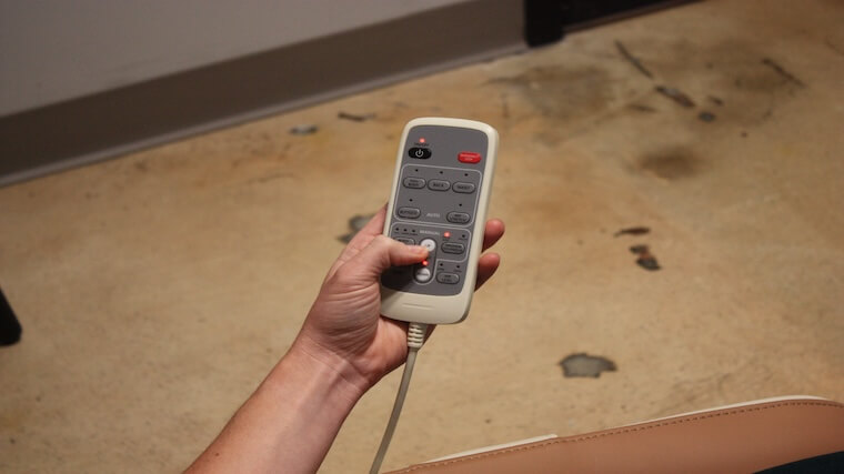 Our tester adjusting the settings on the Synca Wellness CirC Massage Chair