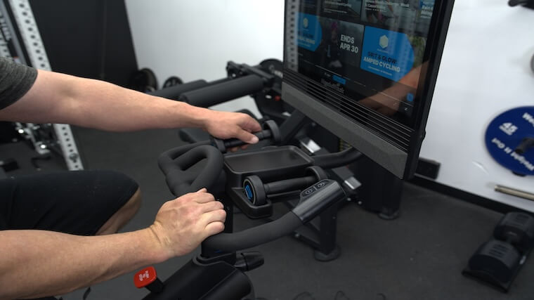 Our tester using the included dumbbells of the NordicTrack X24 Bike