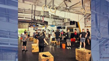 CrossFitters standing around a gym