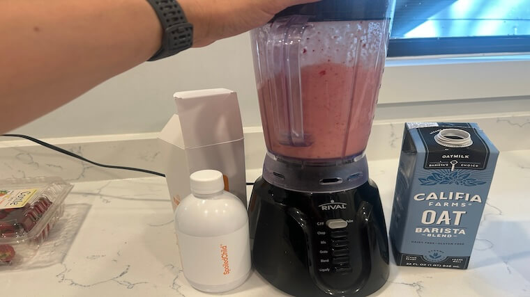 Our tester making a smoothie with Spoiled Child Liquid Collagen, oat milk, and fresh berries