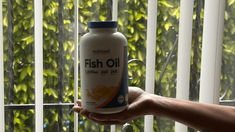 Our tester holding a full container of Nutricost Fish Oil