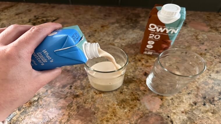 Our tester pouring their sample of OWYN Protein Shake into a glass