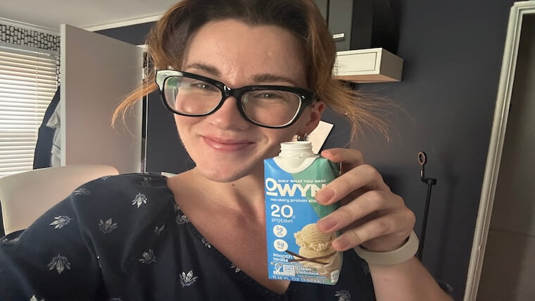 Our tester enjoying a carton of OWYN Plant-Based Protein Shake