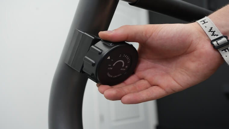 Our tester adjusting the resistance on the Sunny Health and Fitness Essential Recumbent Bike