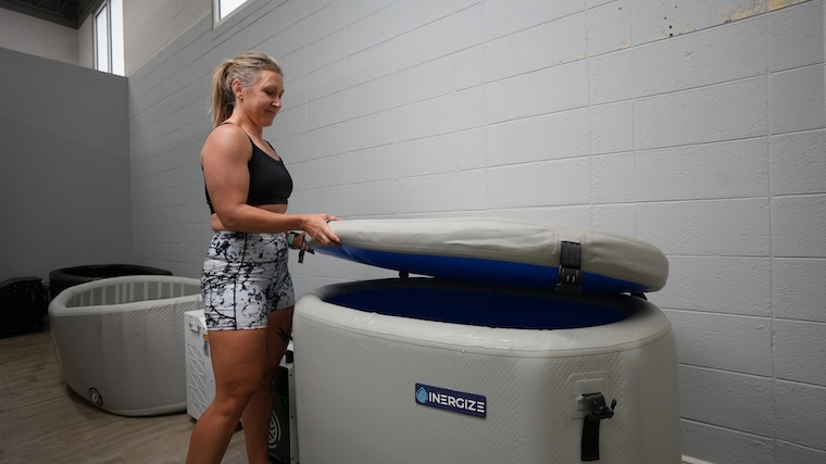 Our tester opening the top lid of the Inergize Cold Plunge: Elite Tub
